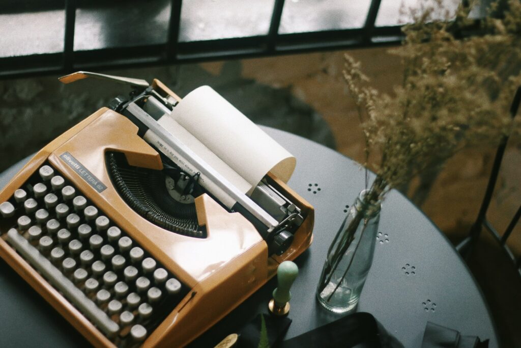 typewriter on writers' desk - Photo by Luke Lung on Unsplash