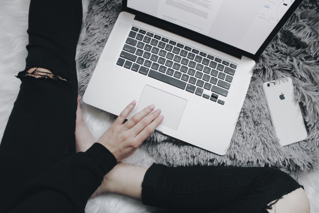 Person in black jeans writing - Photo by Mikayla Mallek on Unsplash


