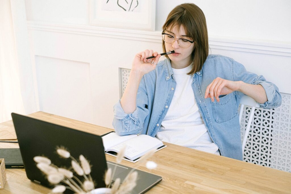 A writer thinking about her writing - Photo by Ivan Samkov