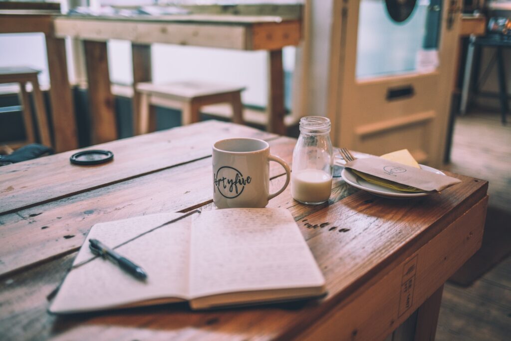 Notebook open on a cafe table