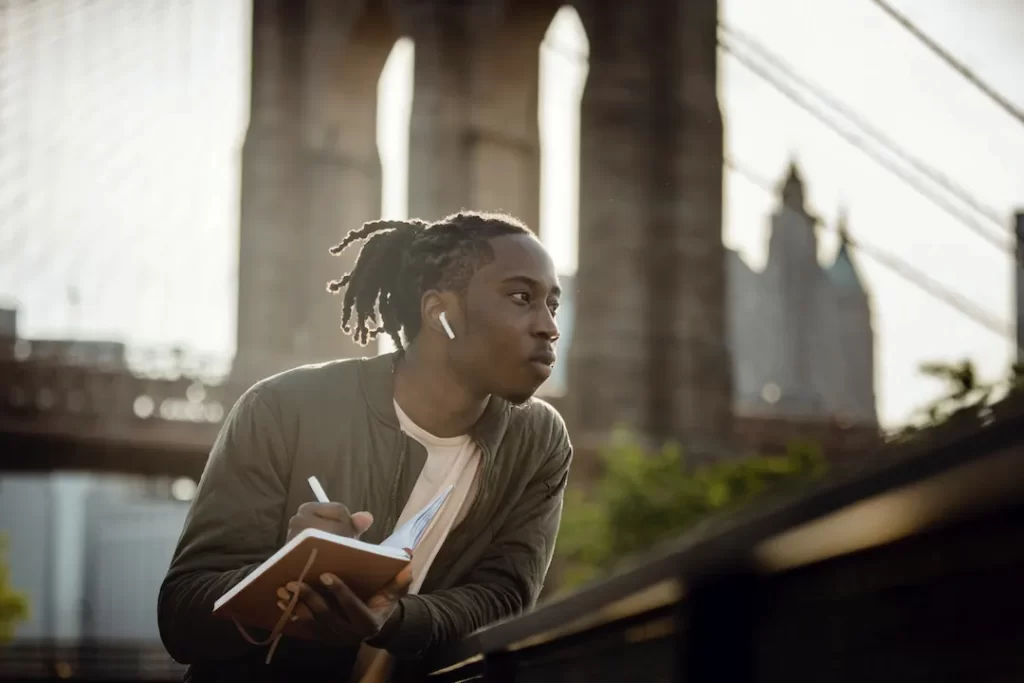 a man writing in a notebook