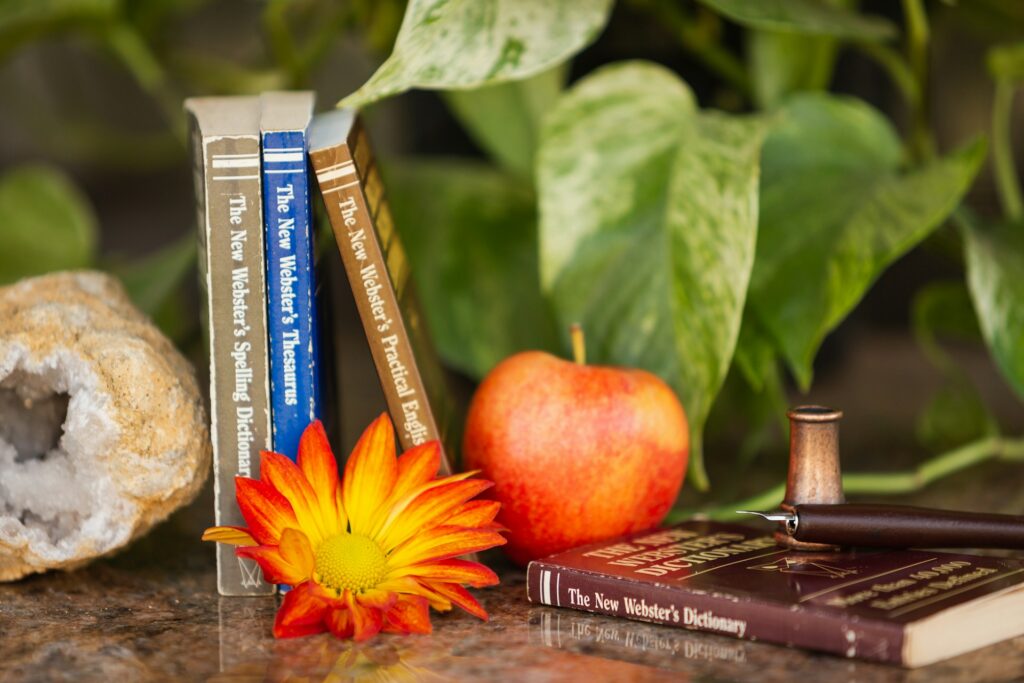 Reference books on a marble tabletop outlining common writing and publishing terms - Photo by Laura Ohlman on Unsplash