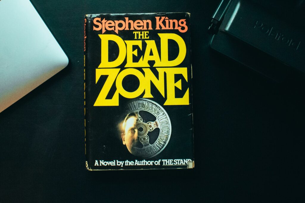 Stephen King's The Dead Zone sitting on a desk - Photo by Bruno Guerrero on Unsplash

